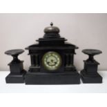 A Victorian slate mantel clock garniture
