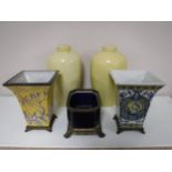 A pair of lidded glazed urns,