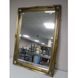 A gilt framed overmantel mirror