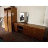 A mid twentieth century oak double door wardrobe together with dressing table and three drawer