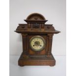 An Edwardian pine mantel clock with enamel dial