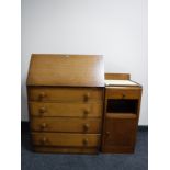 A mid twentieth century oak bureau together with a mahogany bedside cabinet