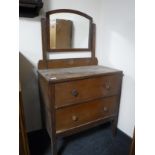 An early twentieth century oak two drawer dressing table