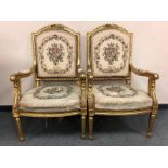 A pair of French gilt armchairs with tapestry upholstered seats