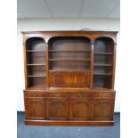A mahogany Regency style bookcase fitted cupboards and drawers beneath