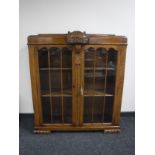 An early twentieth century carved oak display cabinet