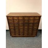 A Victorian and later post office cabinet fitted with forty-two fall front doors,