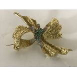 An 18ct gold diamond and emerald bow brooch, 20g,