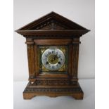 An early twentieth century carved oak cased bracket clock