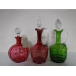 Three antique coloured glass decanters