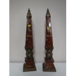 A pair of ornate ormolu mounted obelisks decorated with figures of elephants