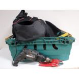 A holdall and crate containing hand tools and power tools