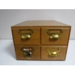 A mid twentieth century oak four drawer index chest