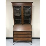 A late Victorian inlaid mahogany bureau bookcase