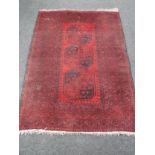 A Bokhara design rug on red ground,