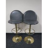 A pair of leather upholstered bar stools on chrome bases