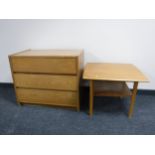 A mid twentieth century teak three drawer chest together with two tier coffee table