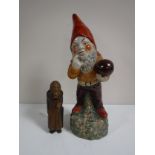 A pottery Gnome figure together with a Swiss wooden nut cracker - Old Lady.