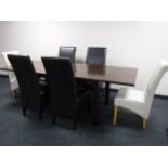 A contemporary pull out dining table together with six high backed leather chairs retailed by
