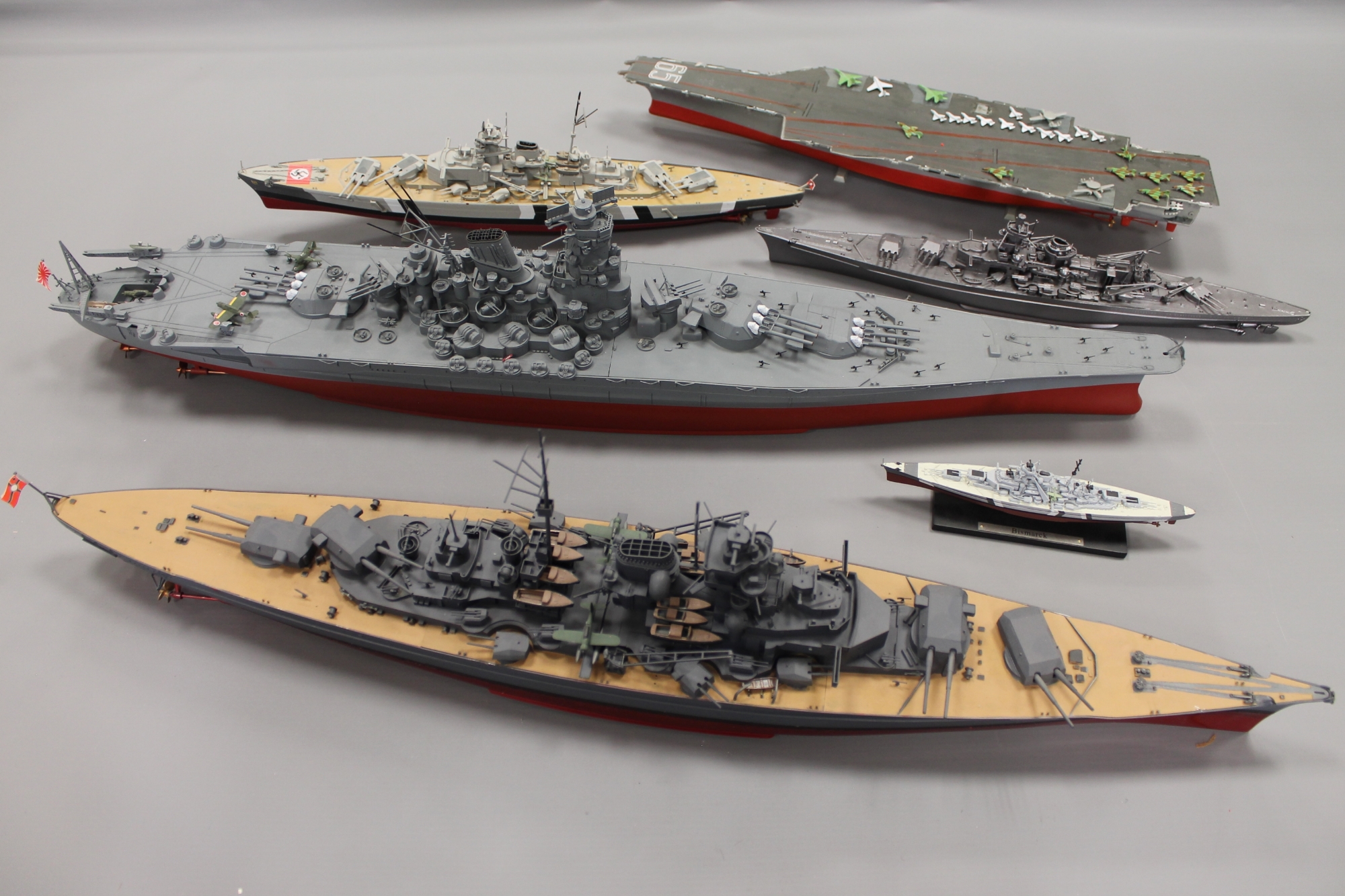 A collection of military model war ships and aircraft carriers.