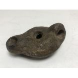 A Roman pottery oil lamp, Capri 2nd-3rd century AD, length 8 cm.