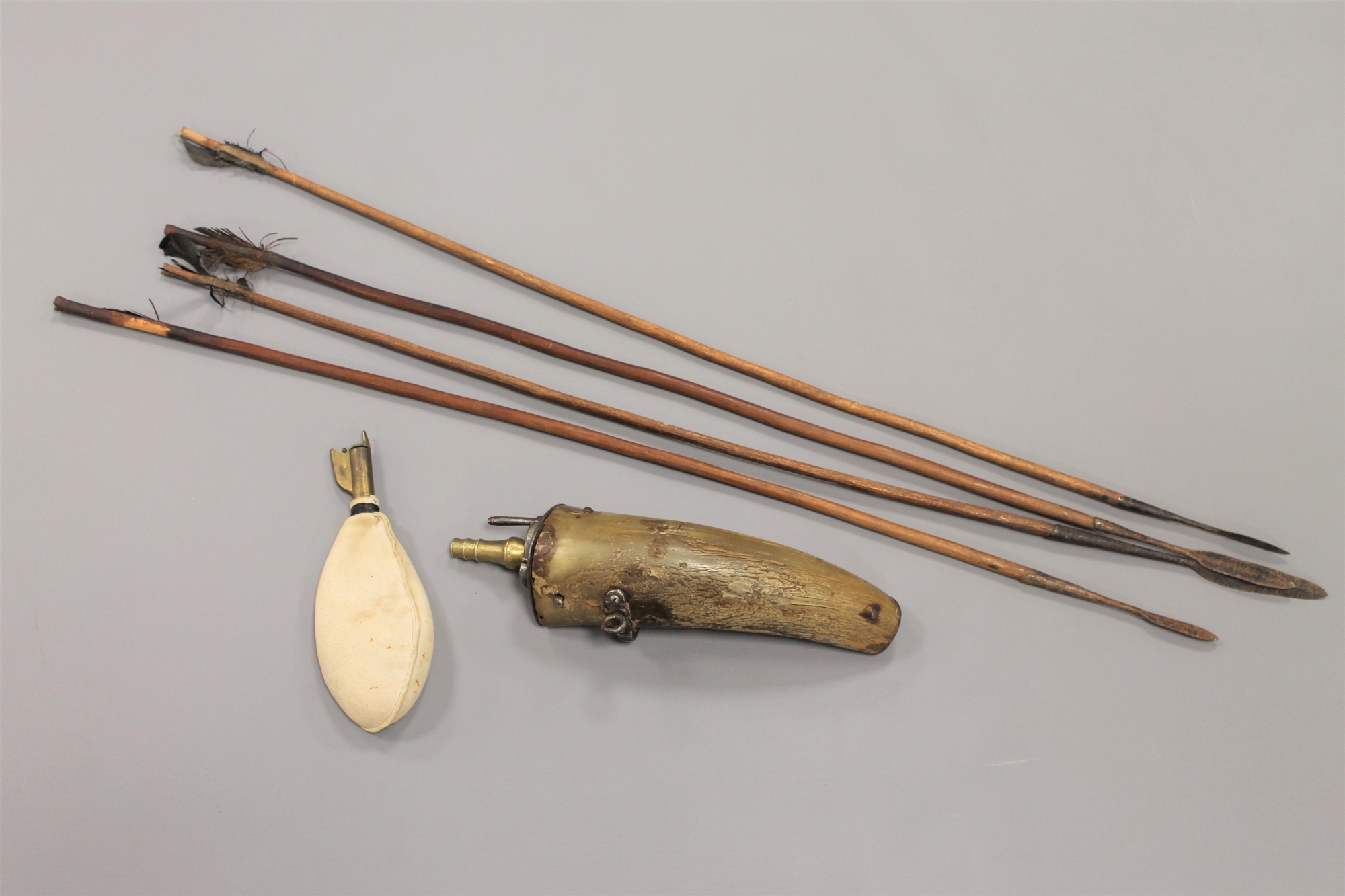 A horn powder flask, together with a shot pouch and 4 tribal arrows.