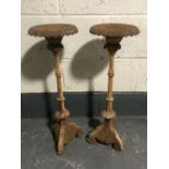 A pair of cast iron garden candlesticks