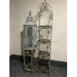 A large hurricane lamp together with a nest of two metal plant stands and a metal four tier whatnot