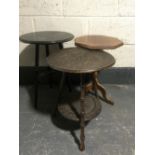 An oak poker work two tier occasional table together with one other occasional table and a plant