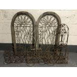 Six metal flower pot trellises together with a metal candle sconce
