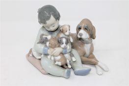 A Lladro figure group - child with dog and puppies