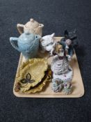 A tray of continental figures, two Kensington ware teapots,