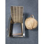 A box of guillotine, wicker storage basket,