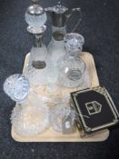 A tray of glass serving tray with four glass decanters (three with labels),