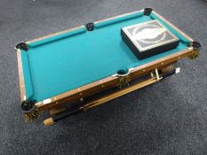 A miniature Brunswick table top pool table with accessories