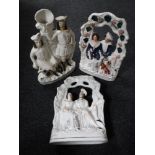 A pair of Staffordshire flat backed figures - Figures seated on a bench together with a