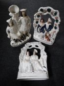 A pair of Staffordshire flat backed figures - Figures seated on a bench together with a