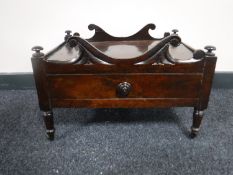 An early Victorian rosewood Canterbury base raised on castors