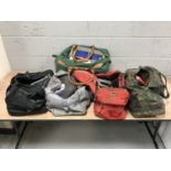 Five holdalls of assorted hand and power tools,