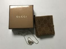 A silver Gucci pendant on chain,