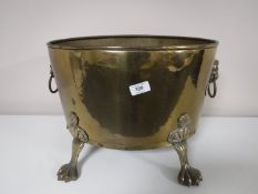 An early twentieth century brass log bin on paw feet CONDITION REPORT: Across the