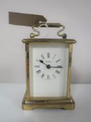 A brass cased carriage clock with key