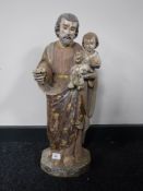 A nineteenth century gilded and polychrome painted wooden figure depicting Christ with child