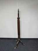 An early 20th century mahogany standard lamp on three way support