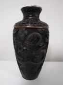 An intricate carved Chinese vase, signed.