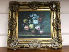 An oil on canvas - still life with flowers in a vase, in an ornate gilt frame, 59 cm x 50 cm .