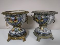 A pair of glazed pottery bowls on gilt metal stands with rim and lion mask handles