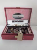 A jewellery box containing assorted costume jewellery and a wristwatch