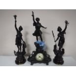 A three piece French spelter clock garniture