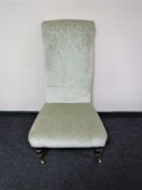 An Edwardian bedroom chair upholstered in a green fabric